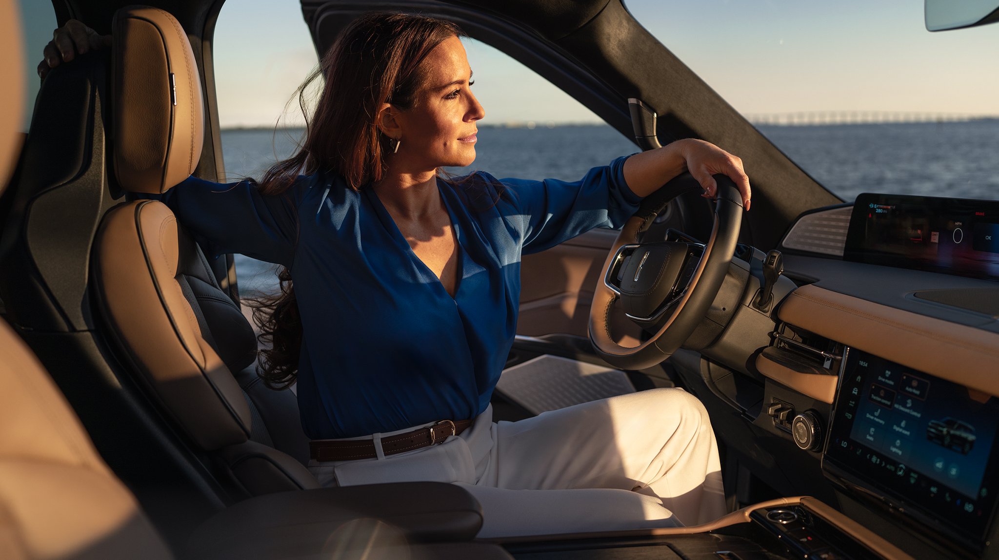 A woman looking out from her Lincoln Navigator.