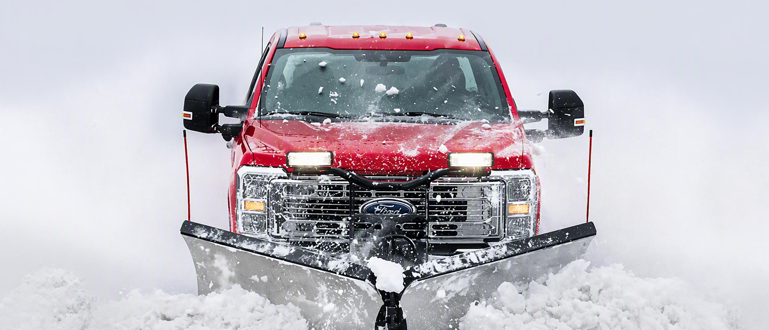 The Ford Super Duty® truck plows snow