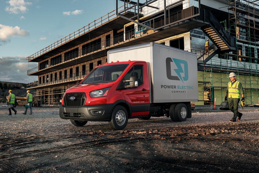 2025 Ford Transit® Chassis Cab with box truck upfit parked at a construction site with a person approaching in safety gear