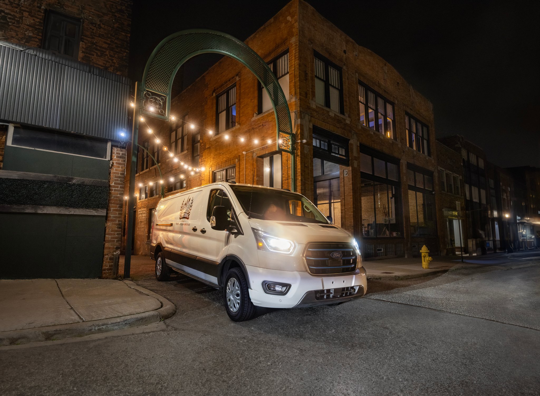 2026 Ford E-Transit™ Cargo Van pulling out of an alley in between buildings