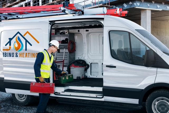 A worker loading a toolbox into the side of an open 2025 Ford Transit® van