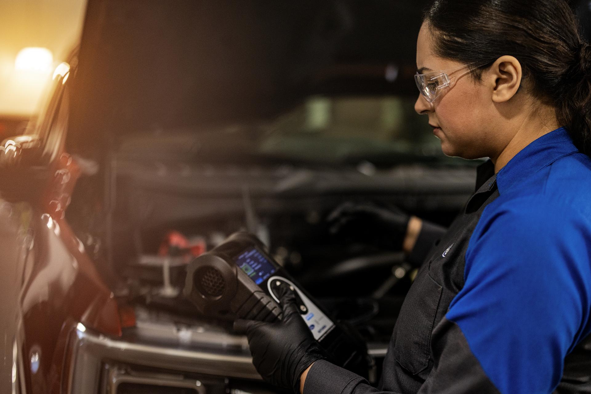 A Ford Service technician tests a battery