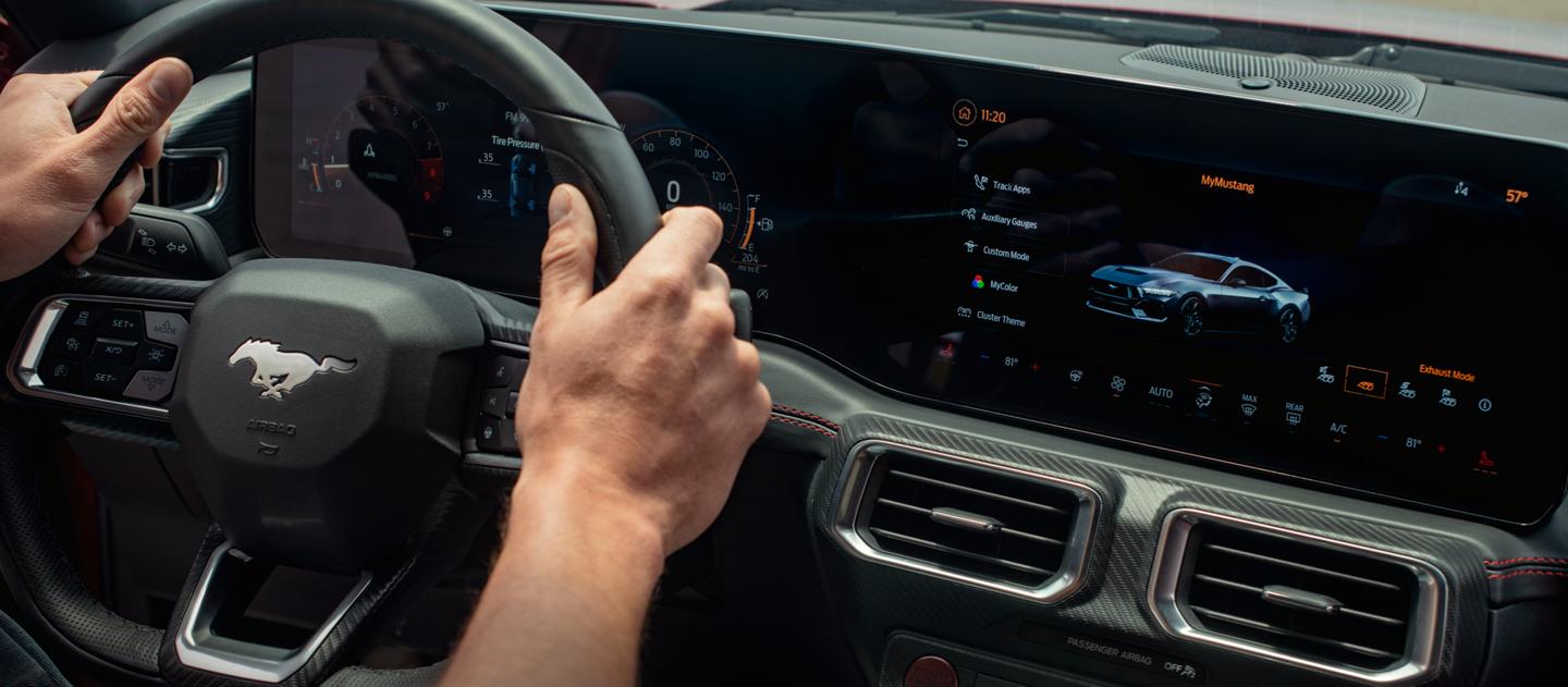Person driving a 2025 Ford Mustang® model with the available 13.2" center touchscreen