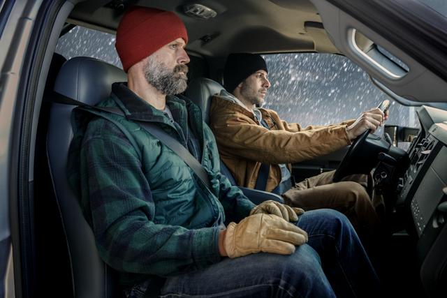 Driver and passenger in winter clothing in front interior of 2026 Ford F-750® Regular Cab