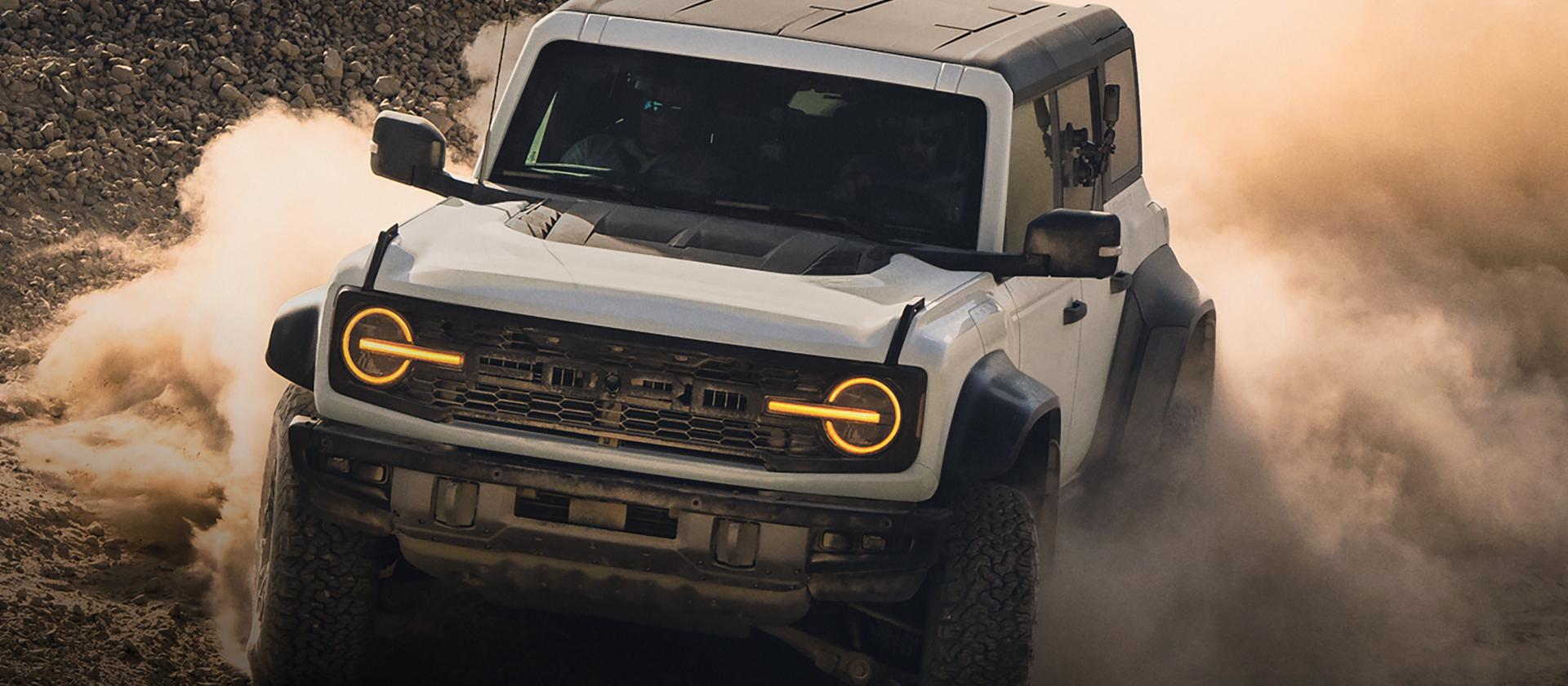 A 2026 Ford Bronco® Raptor® SUV kicking up dust in an empty field