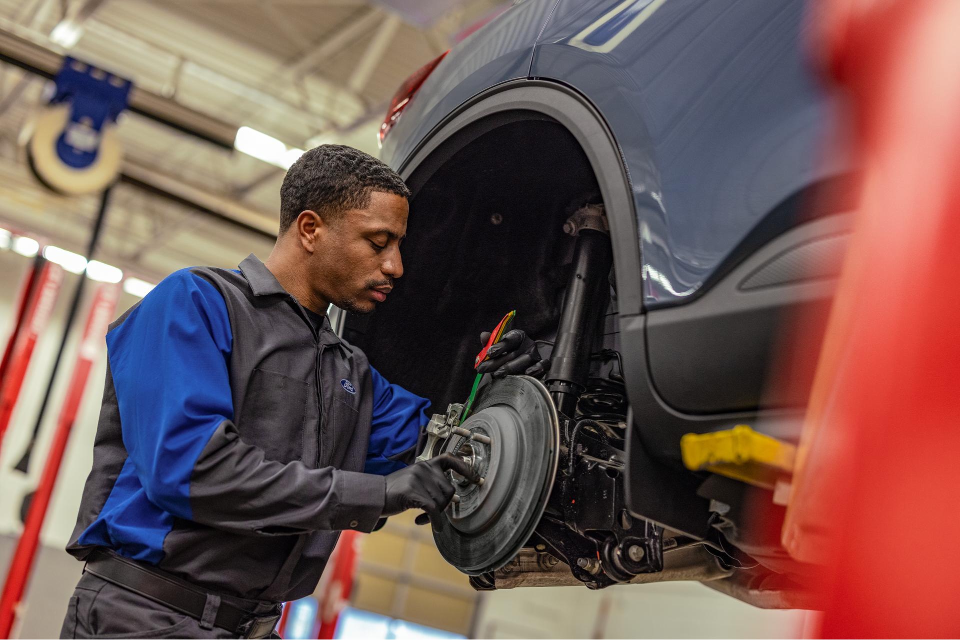 A Ford Service technician replaces brakes and rotors