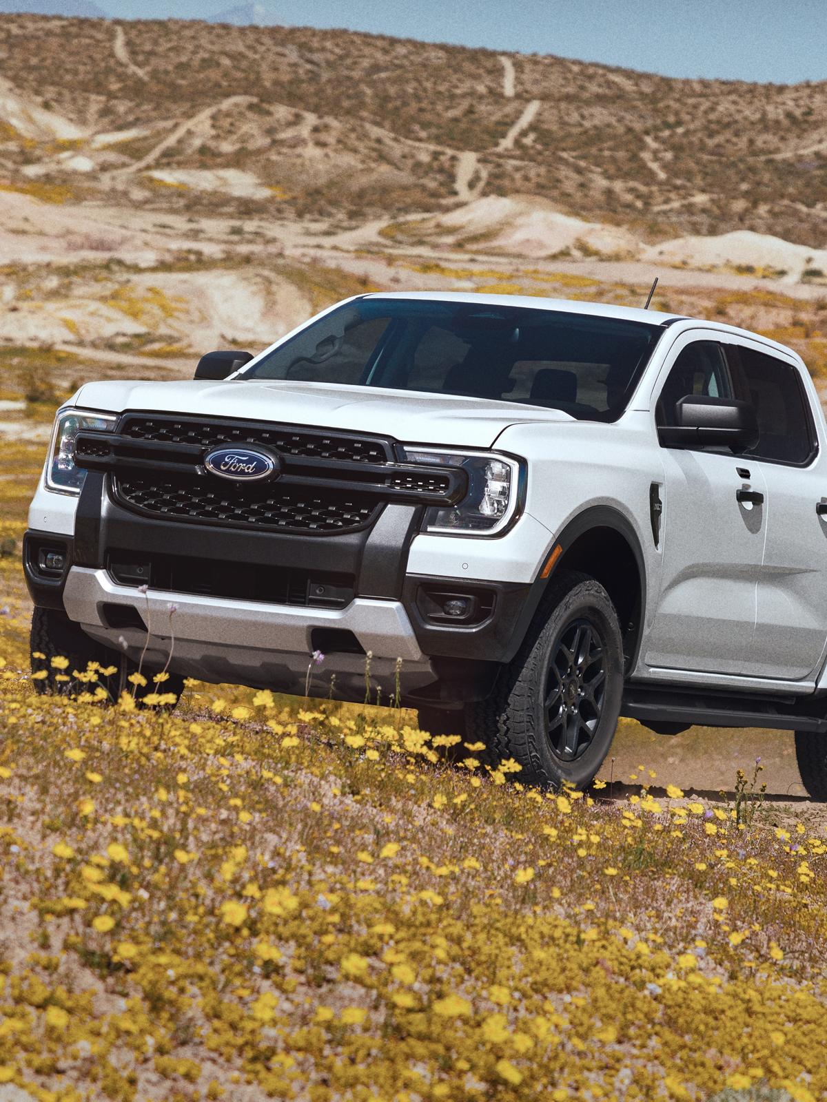 2026 Ford Ranger® XLT truck being driven on an uneven, grassy terrain