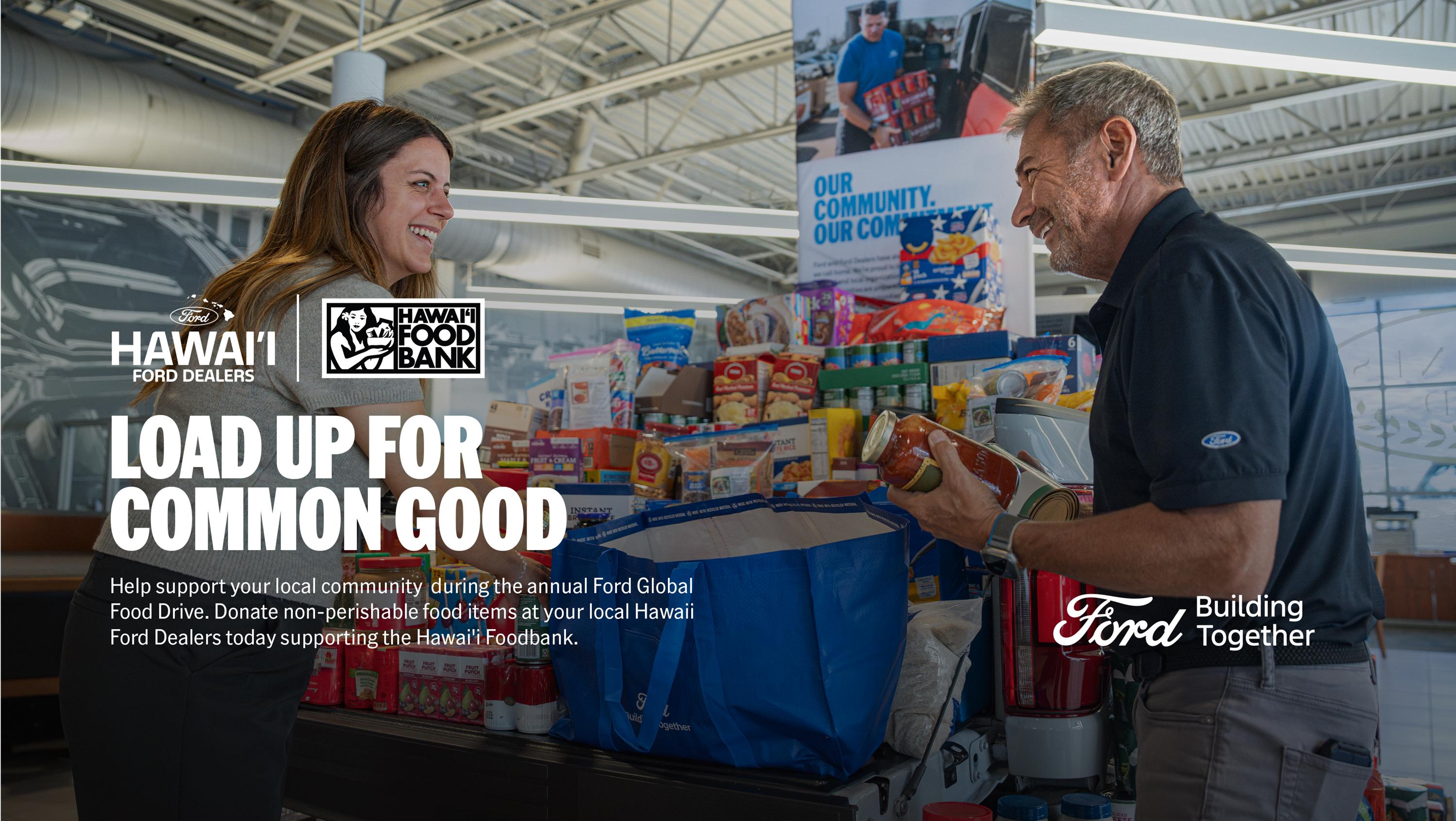 A Ford employee accepts food donations from a customer.