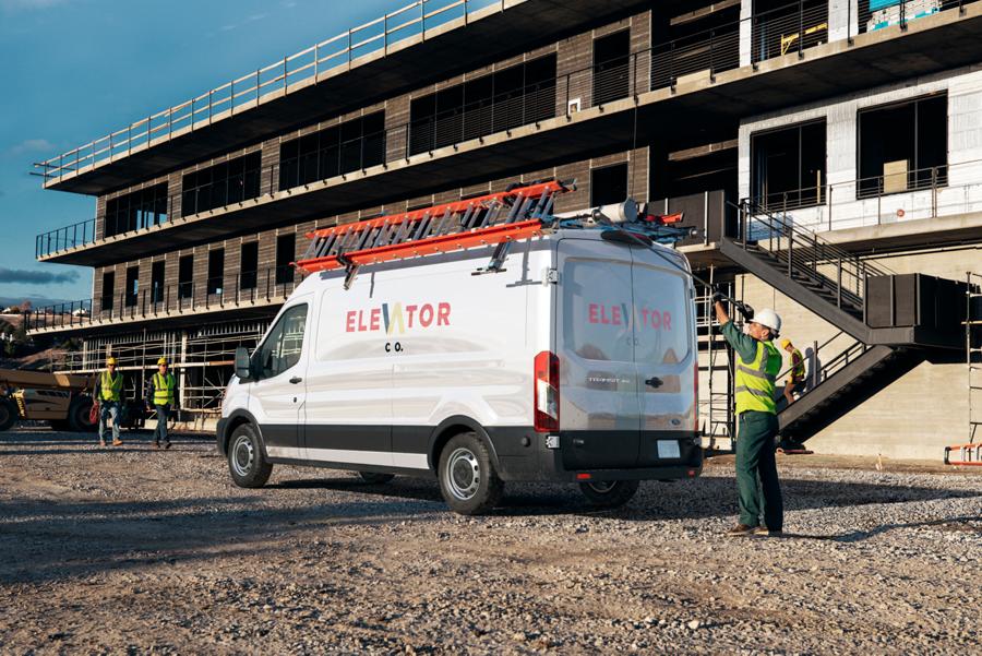 A 2025 Ford Transit® van parked at a job site with ladders on it