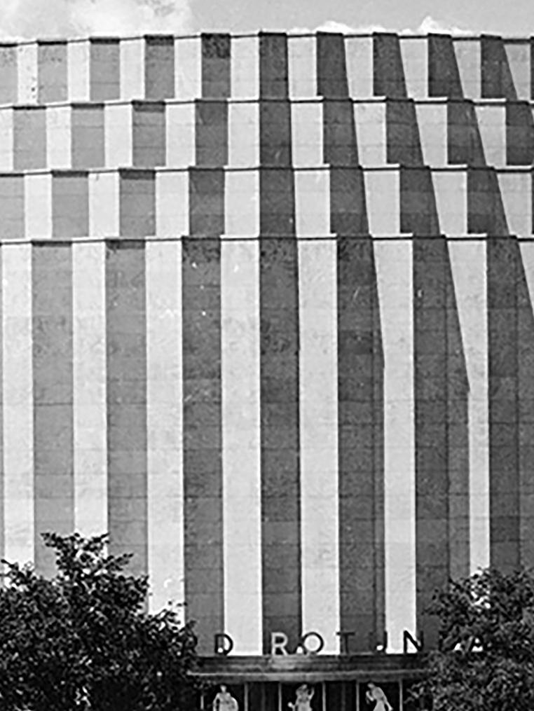 A black and white photo of a round building, the Ford Rotunda