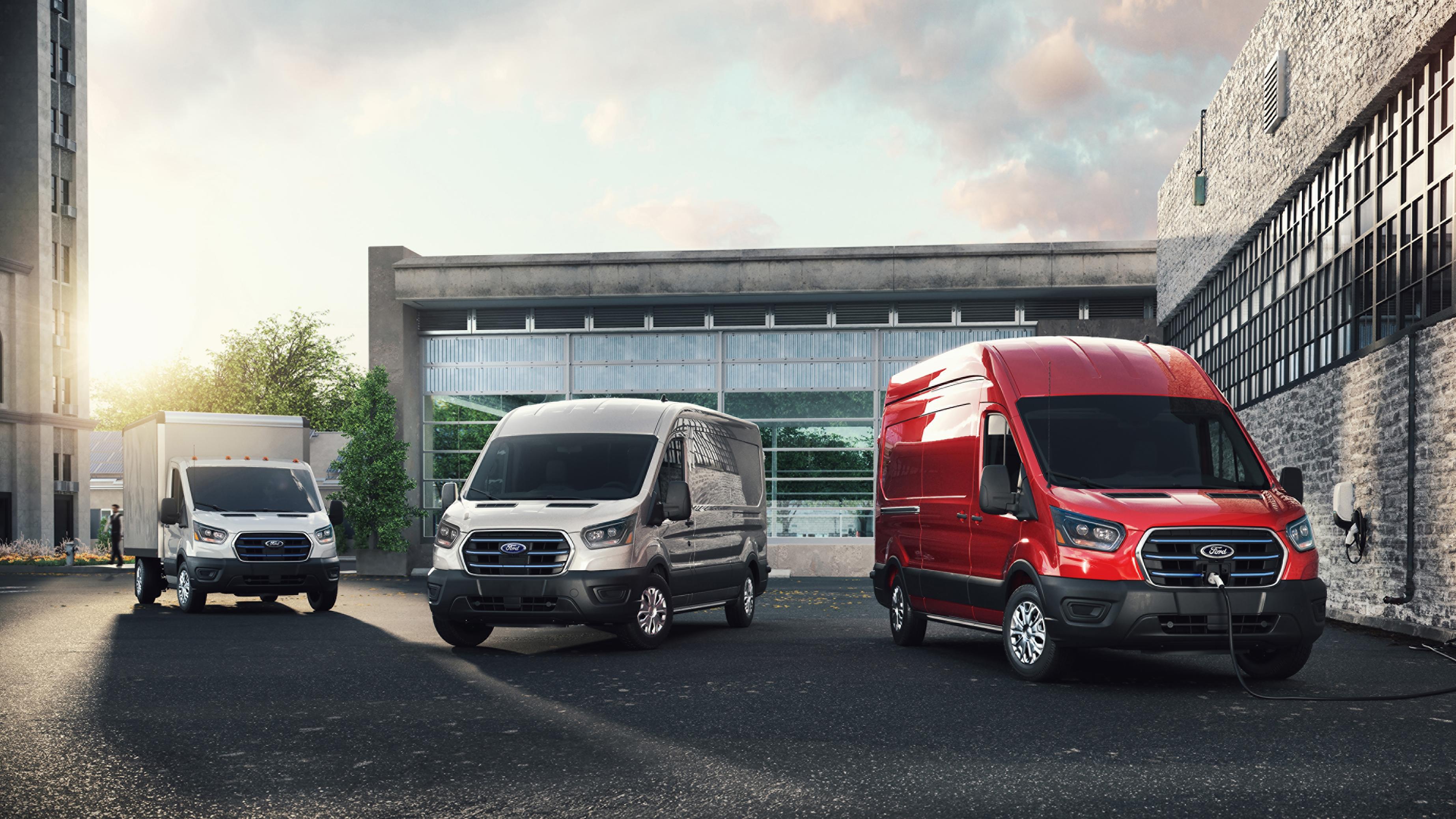 Ford E-Transit™ models parked in front of an office building