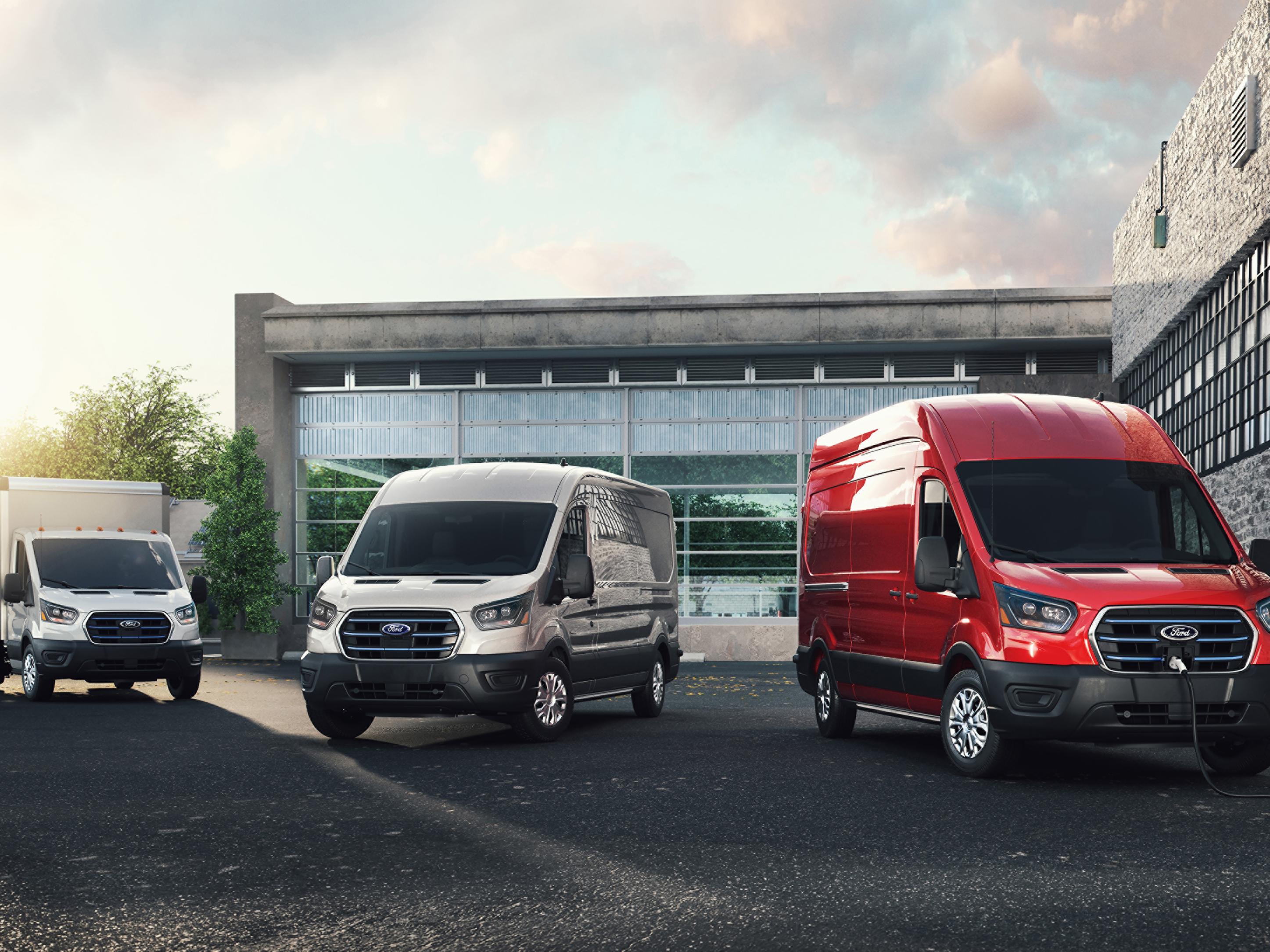 Ford E-Transit™ models parked in front of an office building