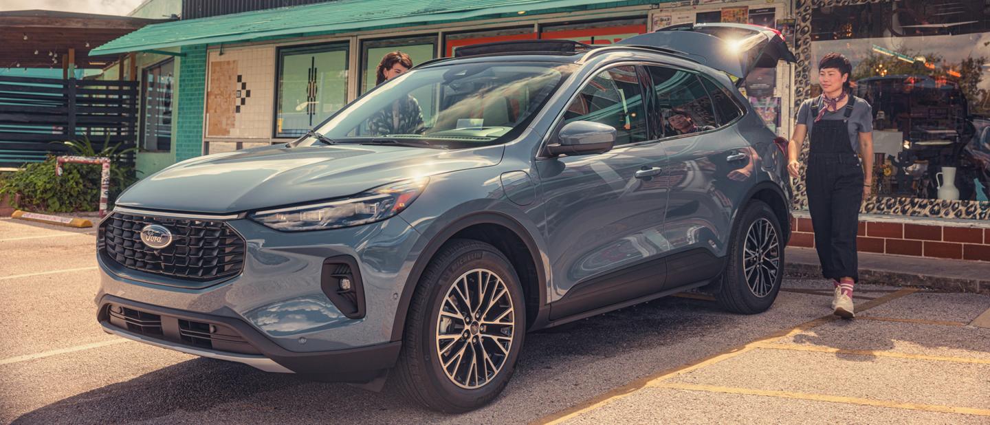 An Escape® Plug-In Hybrid being loaded at the door of a storefront