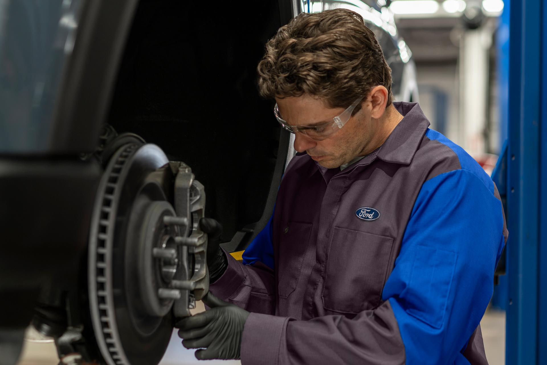 A Ford Service technician services a Ford vehicle