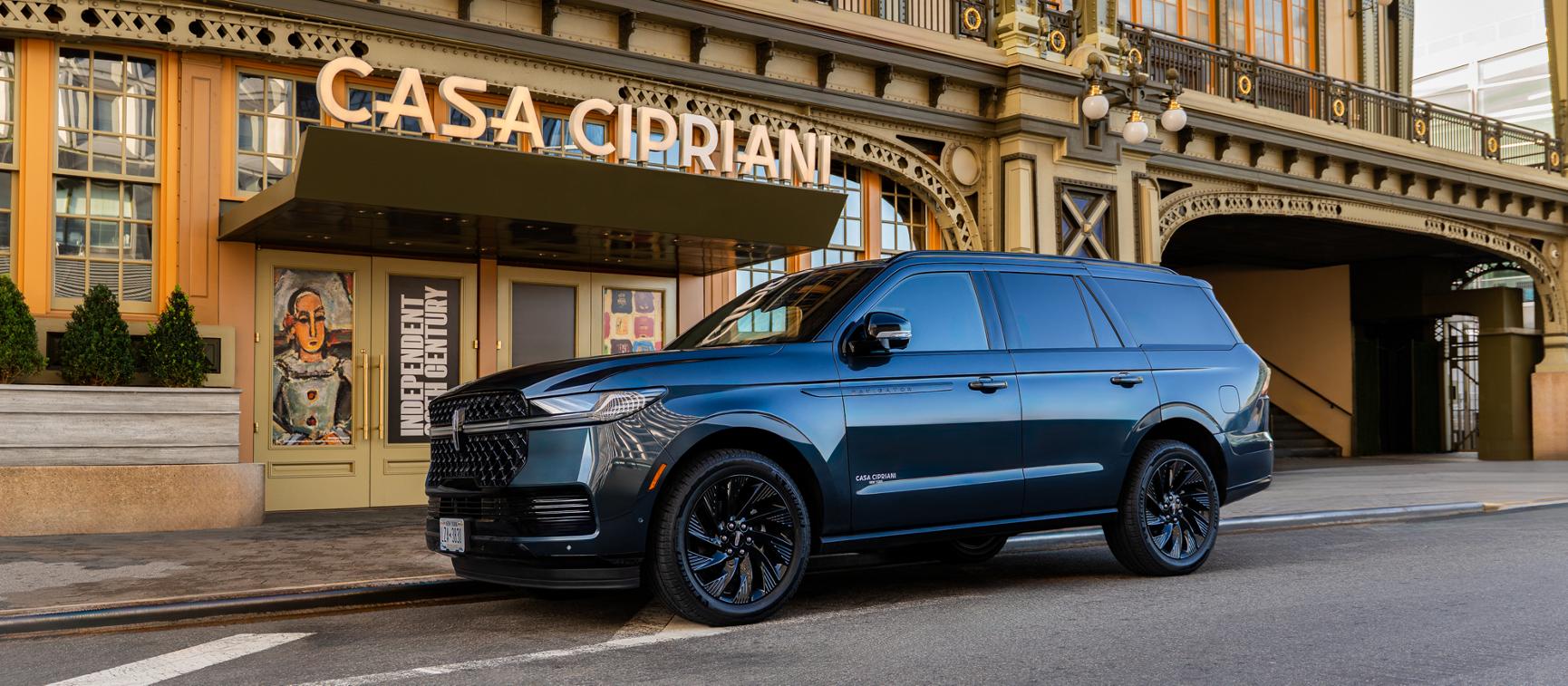 The Lincoln Navigator parked outside a building.