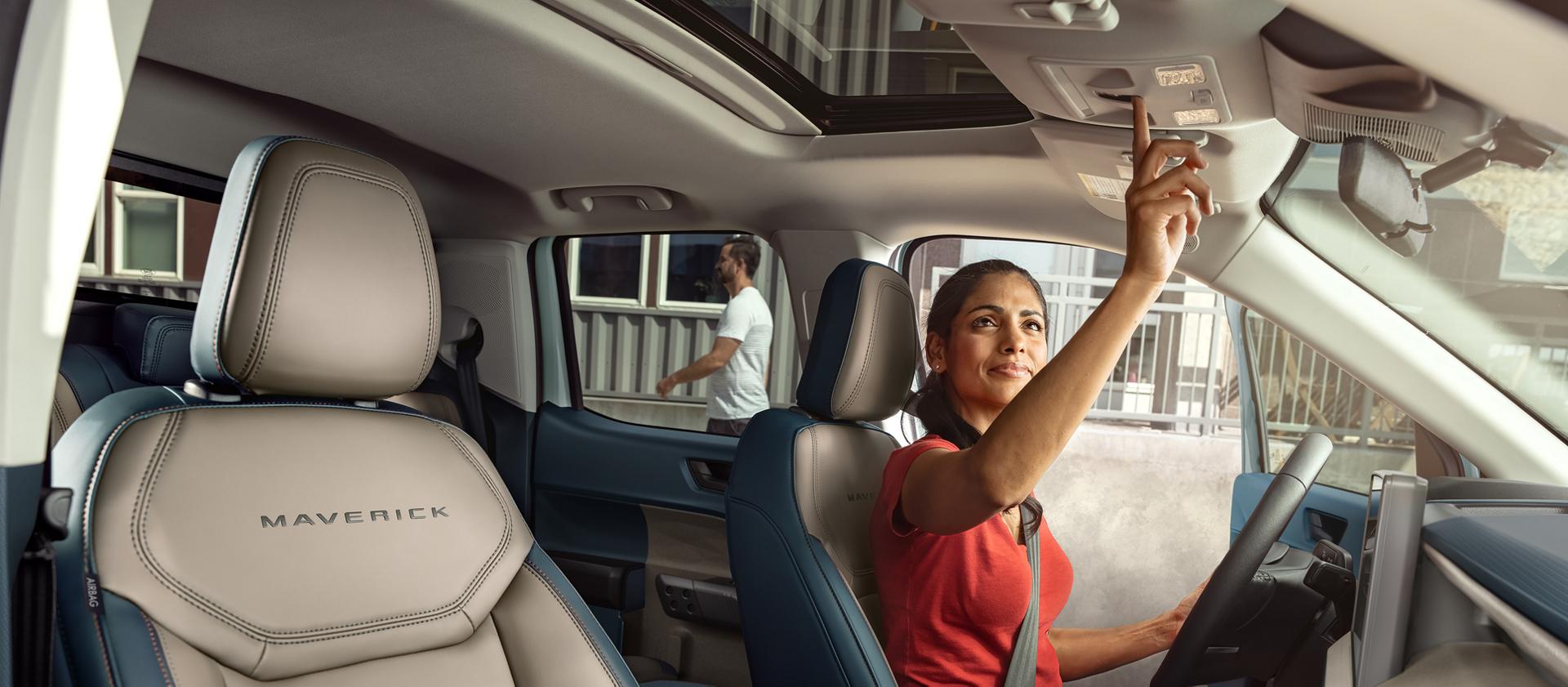 Woman using the moonroof controls of a 2026 Ford Maverick® Lariat® pickup