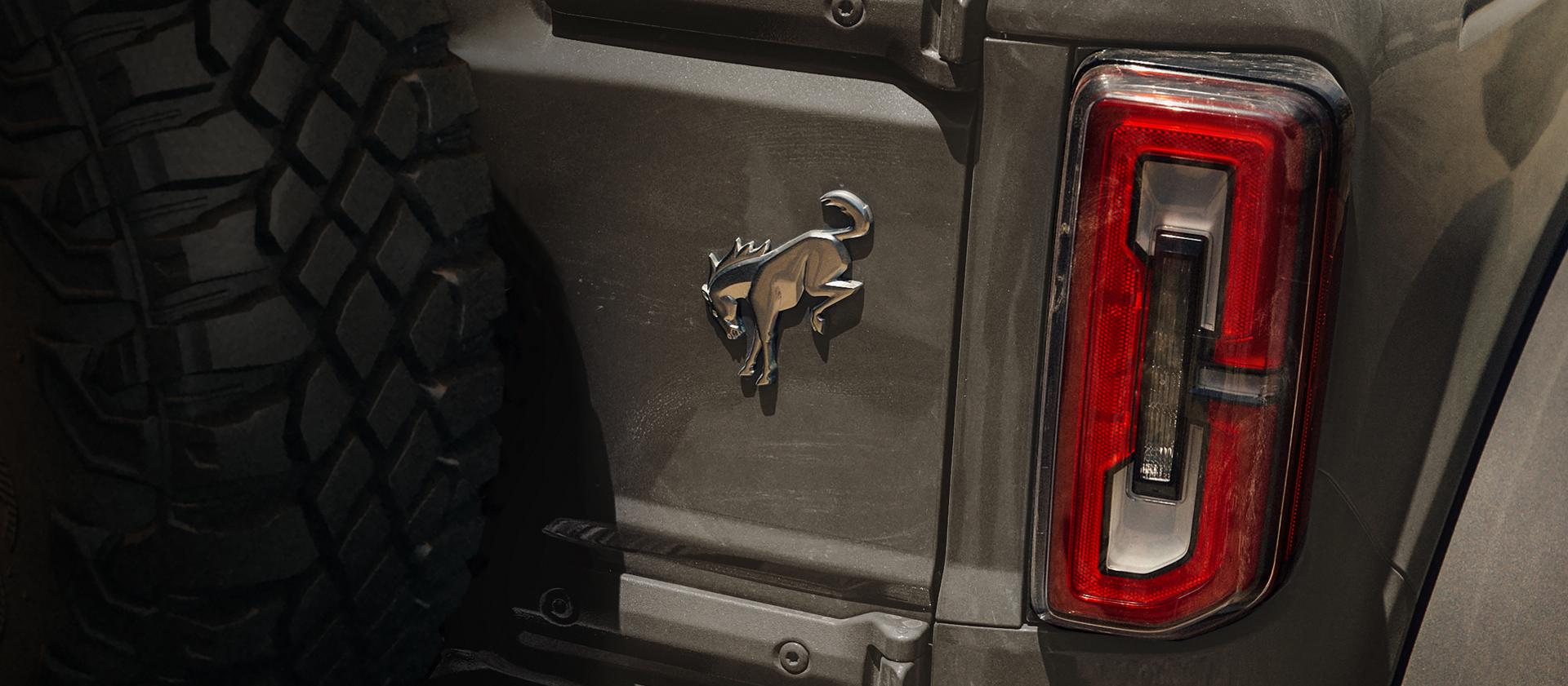 A close-up of the Bronco badge on the rear swing gate of a 2026 Ford Bronco® Stroppe Edition SUV
