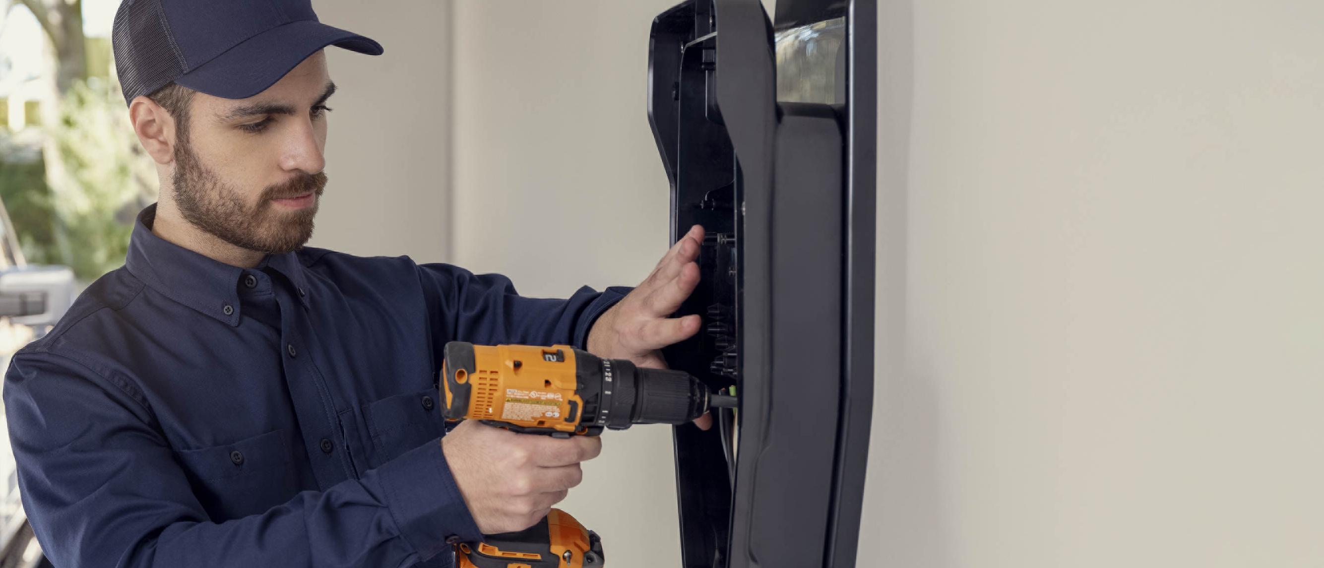 Qmerit technician installing a home charger in a garage