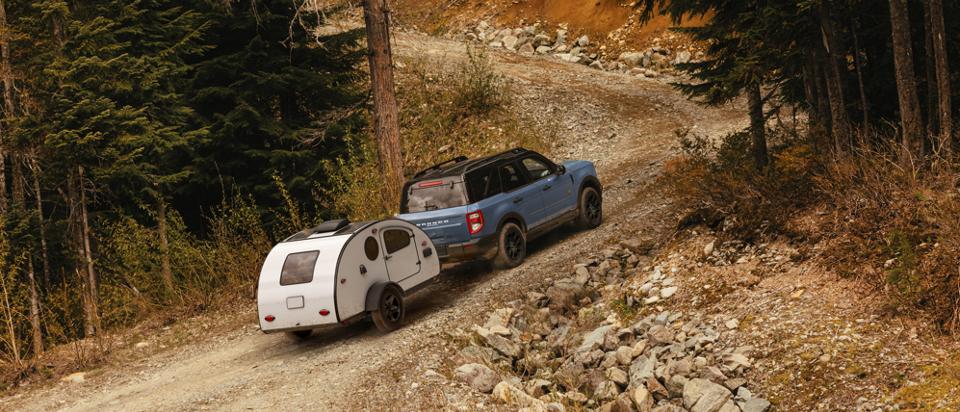 2025 Ford Bronco Sport® towing a trailer and being driven up an incline