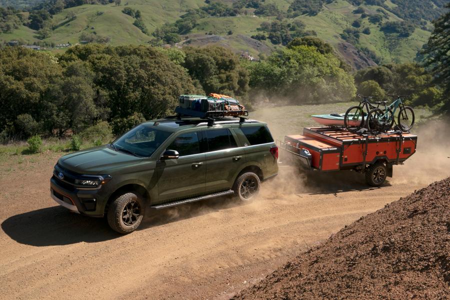 A 2025 Ford® Expedition® is being driven off-road hauling bikes and a kayak