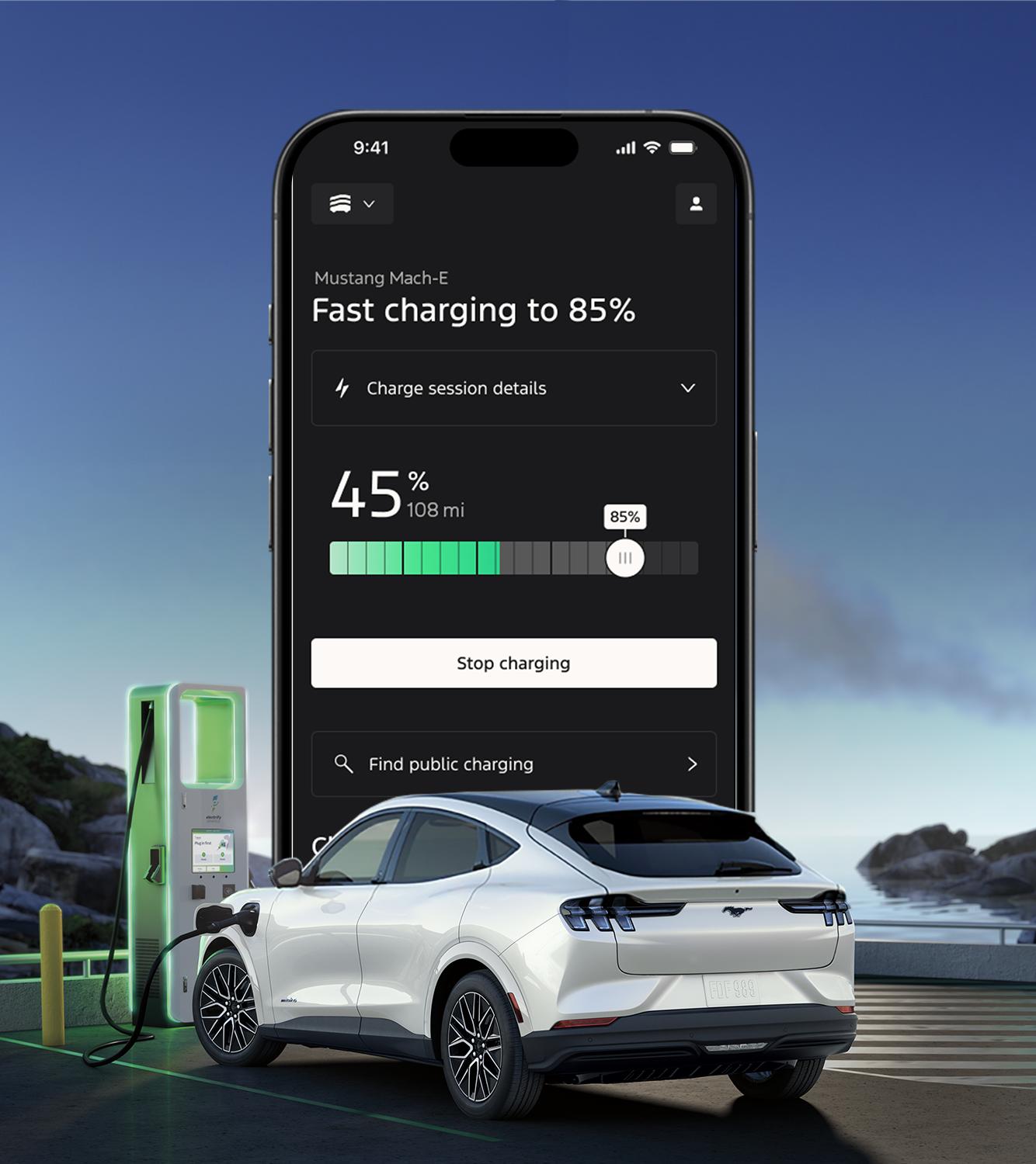 The Ford app screen displays on the horizon behind a 2026 Ford Mustang Mach-E® SUV at a charge station