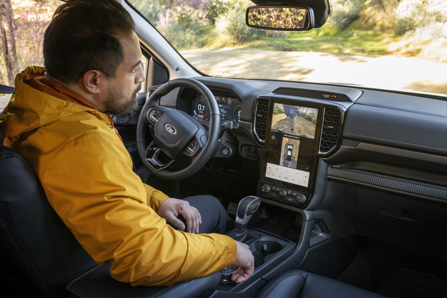 A person sitting in the driver's seat of their 2026 Ford Ranger® Lariat® model and using the 360-Degree Camera feature