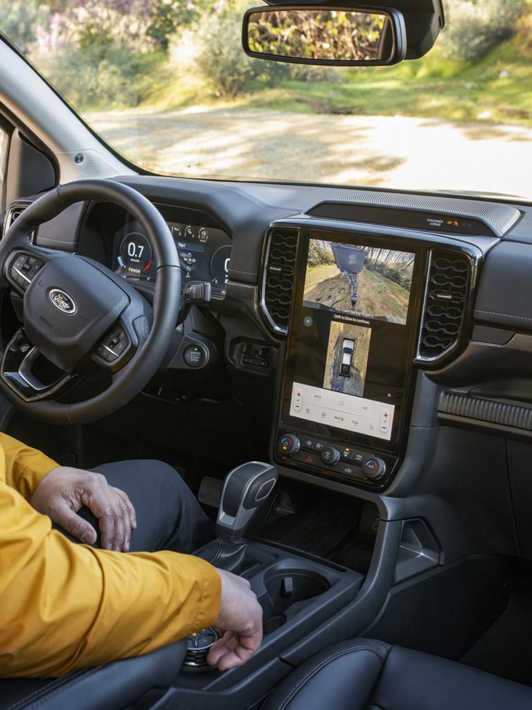 A person sitting in the driver's seat of their 2026 Ford Ranger® Lariat® model and using the 360-Degree Camera feature