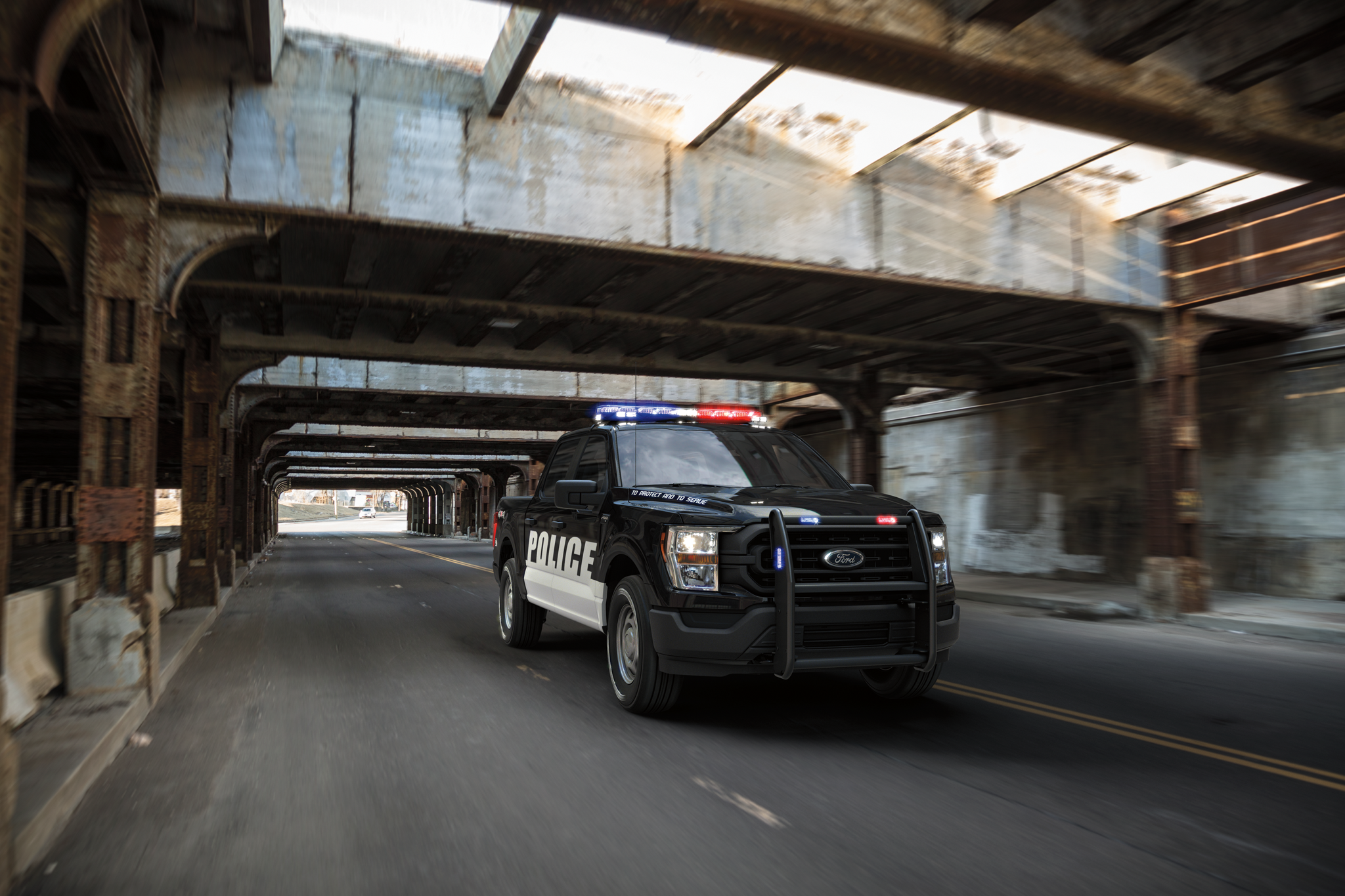 Twenty twenty one ford f one fifty special service vehicle being driven under a bridge