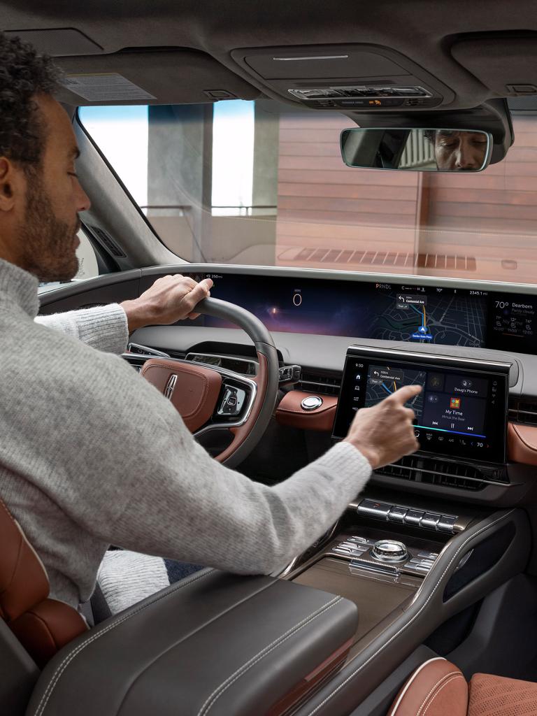 A driver selects an app on their center display