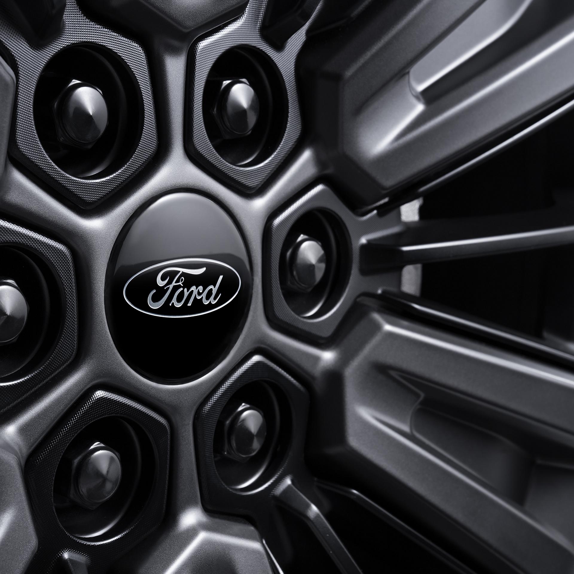 Close-up of the black lug nuts on a 22-inch wheel