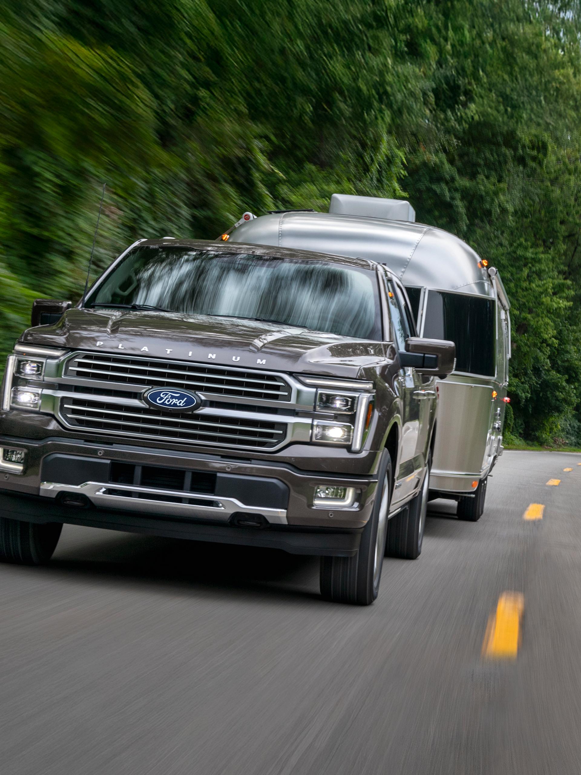 2027 Ford F-150® Platinum® model towing a camper