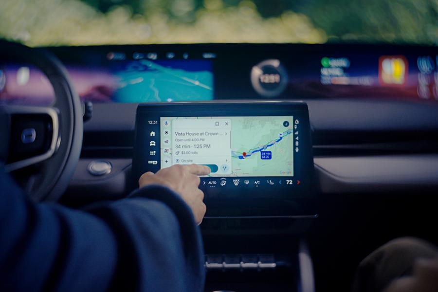 A driver of a 2026 Lincoln Nautilus SUV interacts with the center touchscreen