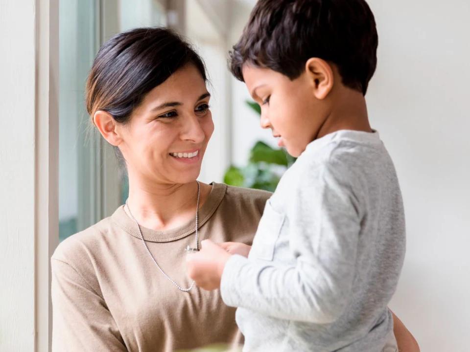 Woman smiling at a child