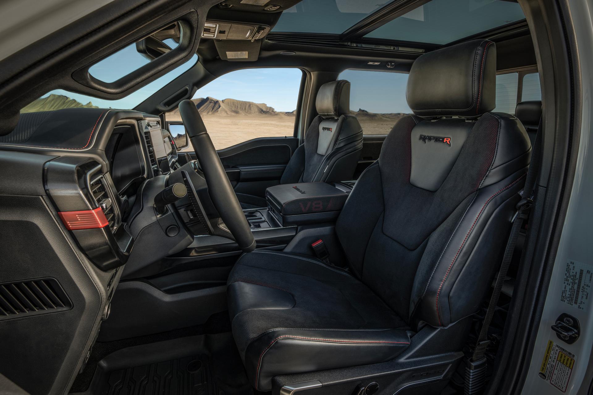 A view of the refined interior of a  2024 Ford F-150® Raptor® R™ showing the black leather sport seats and modern cockpit