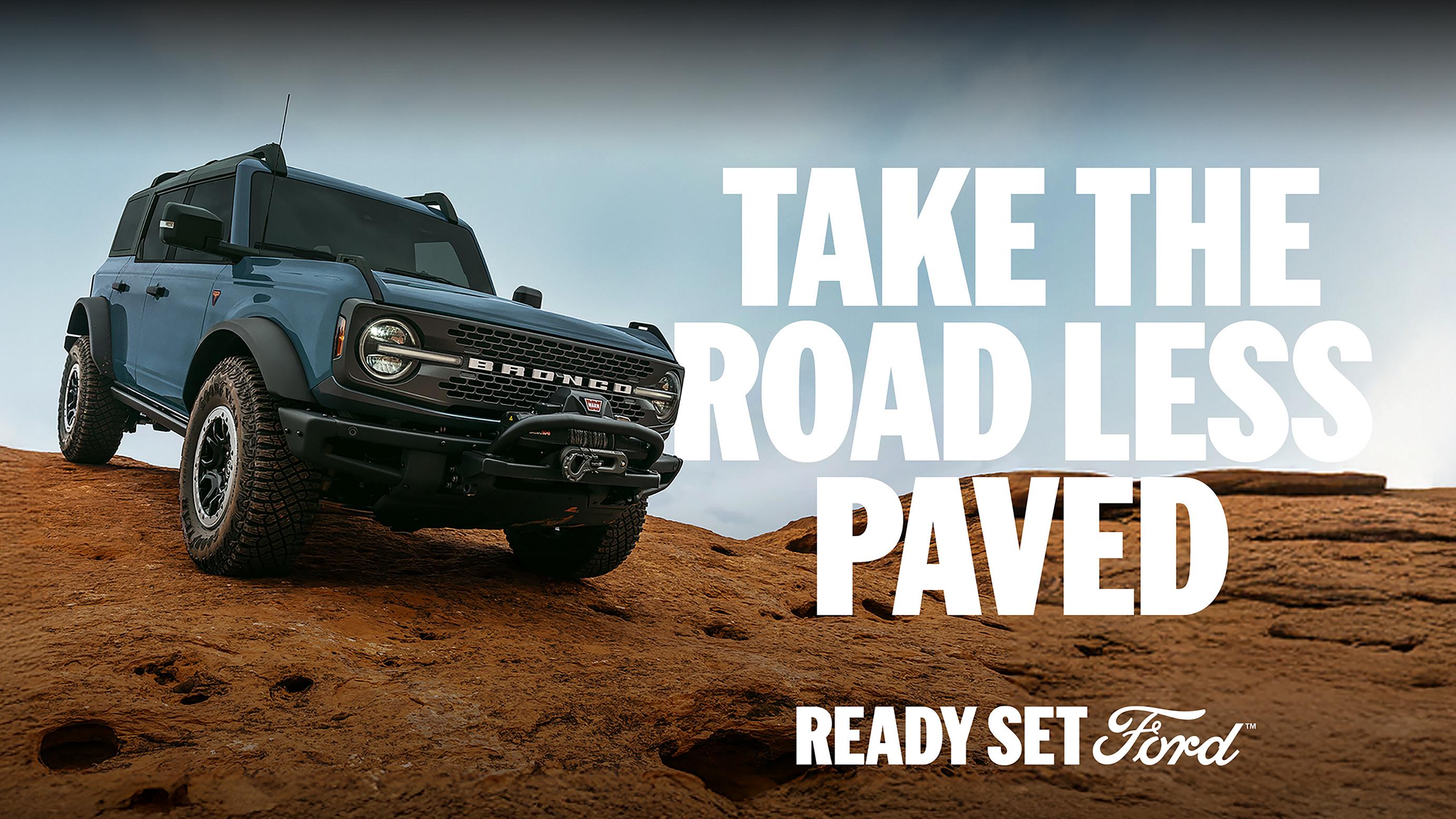 The 2025 Ford Bronco® Badlands® SUV parked triumphantly on top of a large rock formation