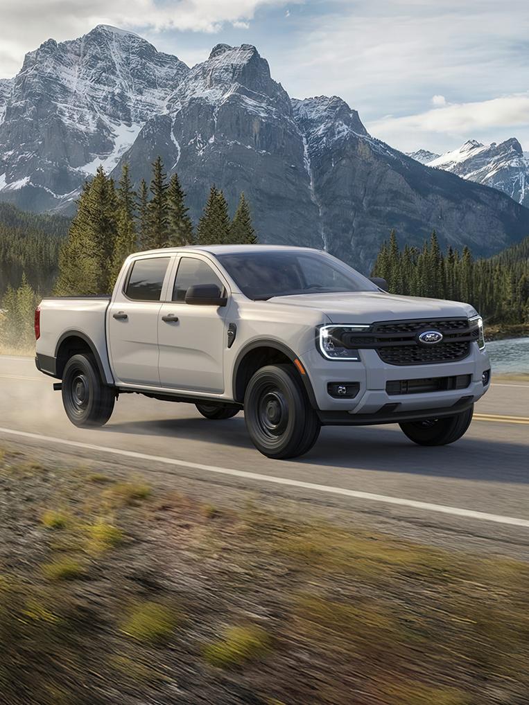 The 2026 Ford Ranger® truck being driven through the mountains