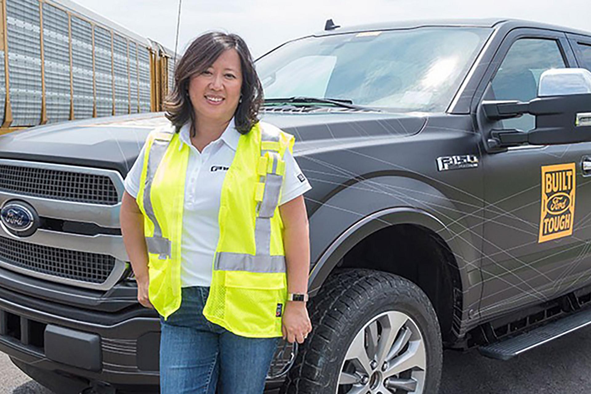 Linda Zhang, chief engineer of the Ford F-150, with the F-150 all-electric prototype