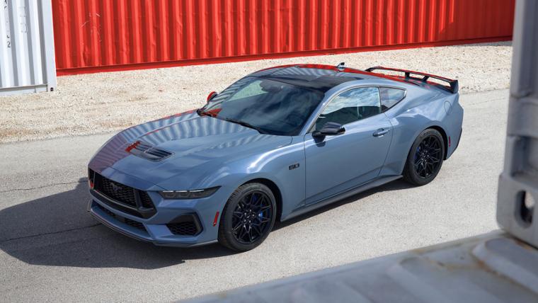 2025 Ford Mustang® GT coupe with Mustang Nite Pony Package parked near shipping containers