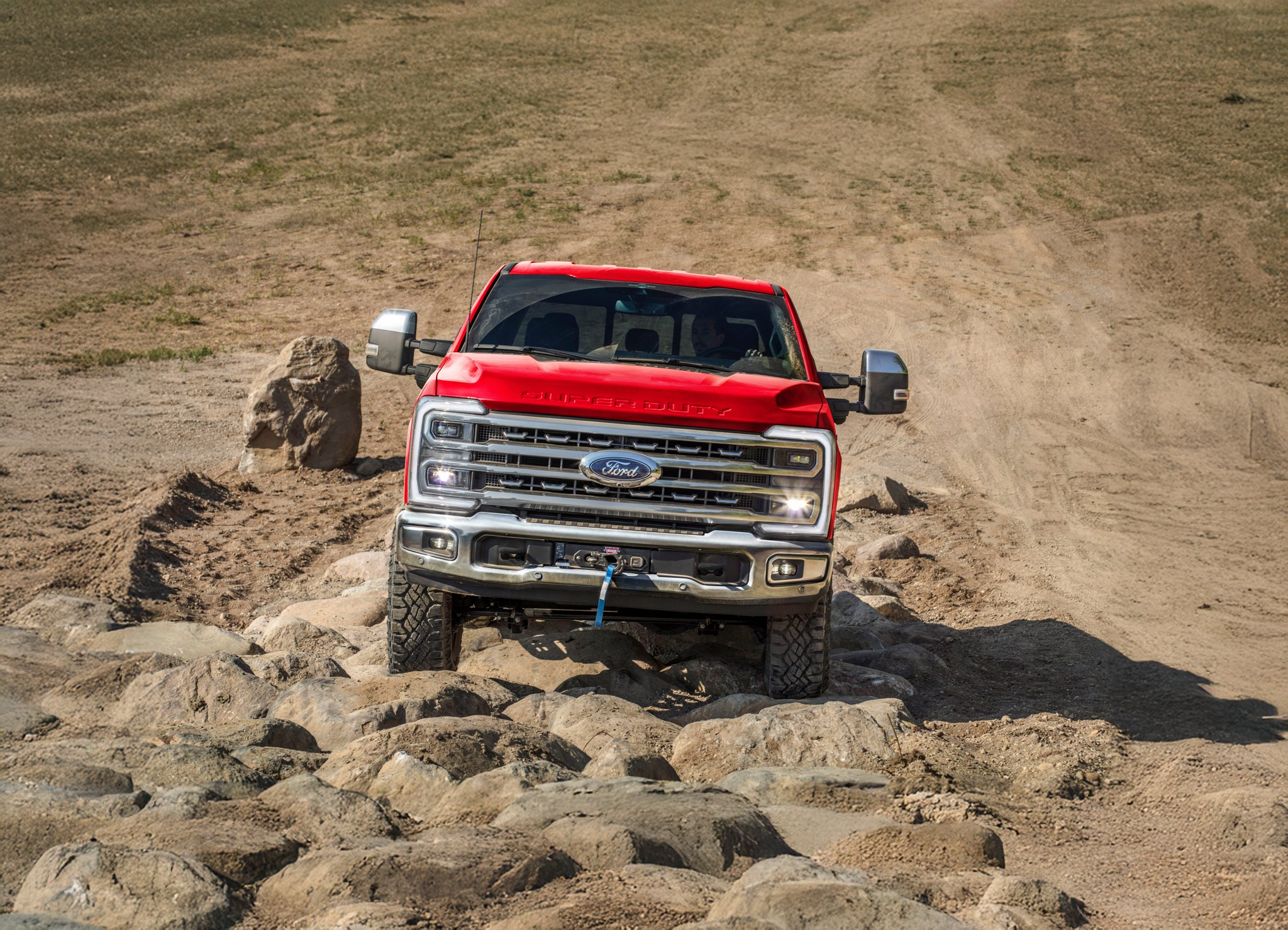 2026 Ford Super Duty® F-250® pickup with the Tremor® Off-Road Package driving on rocky terrain
