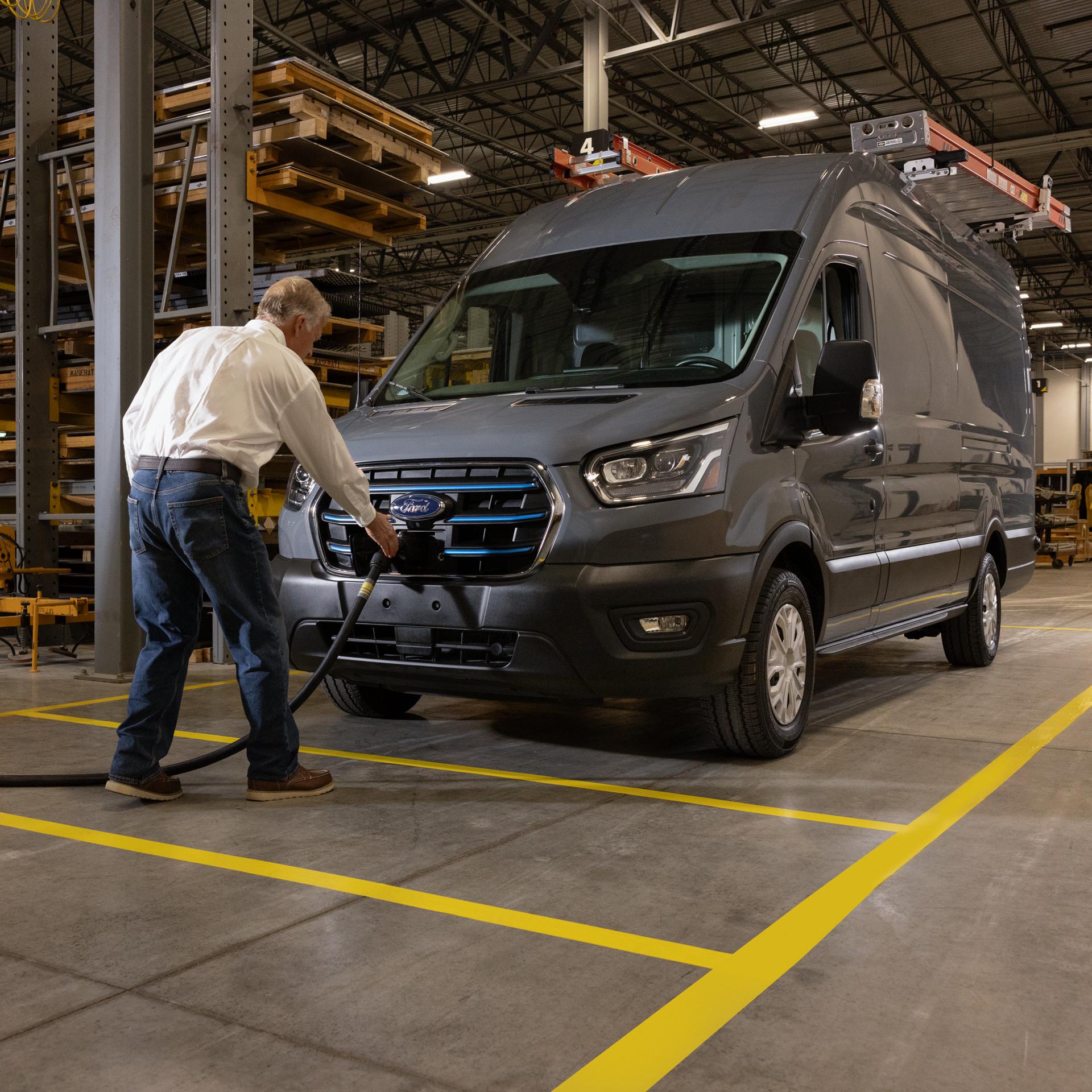 Person plugging in a Ford E-transit™ in a shop environment