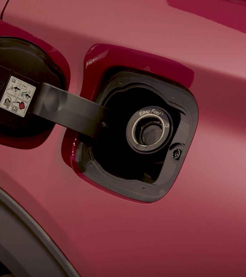 A red vehicle with the fuel door open