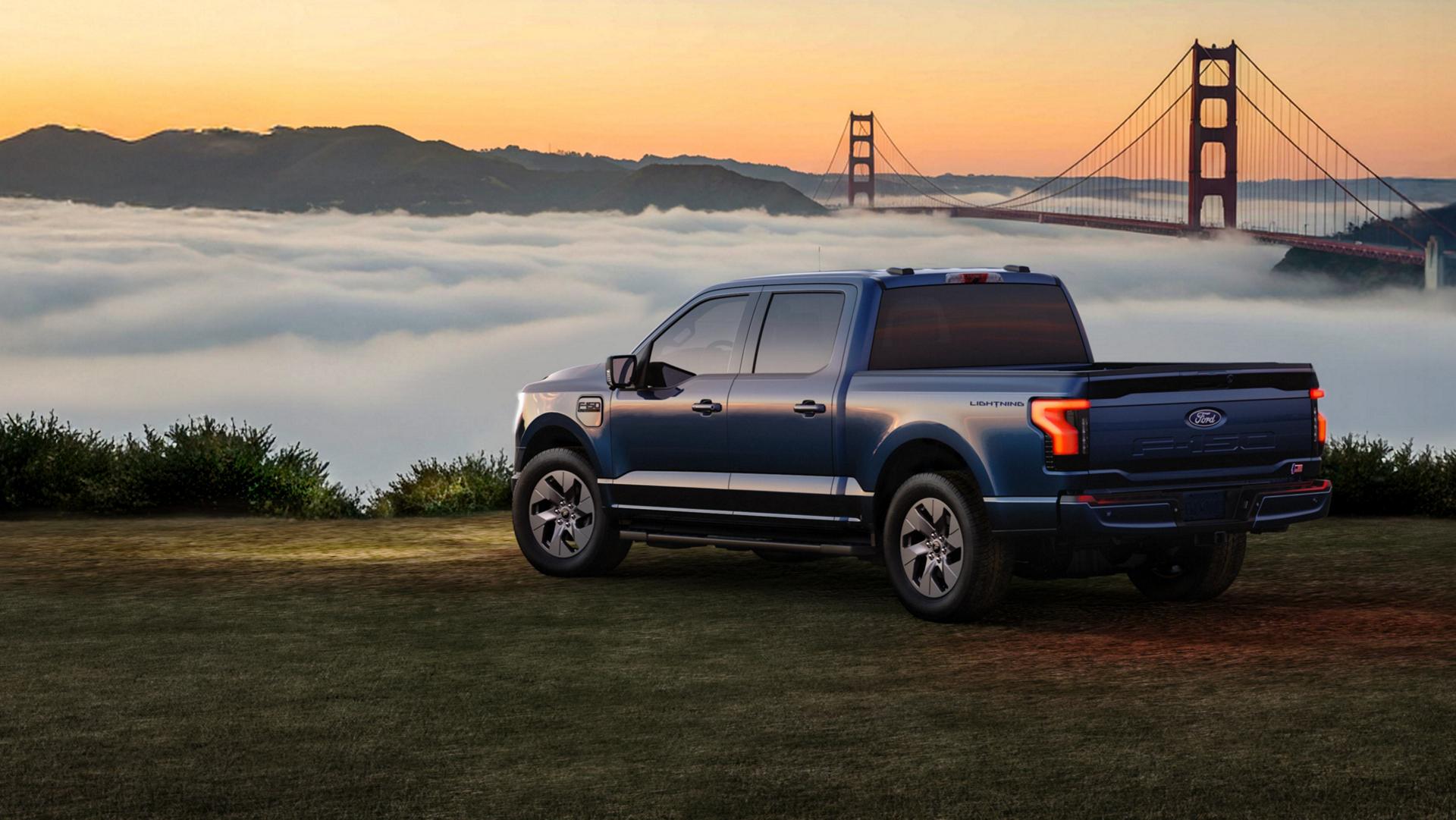 2025 Ford F-150 Lightning truck parked on grassy area overlooking a bay filled with clouds
