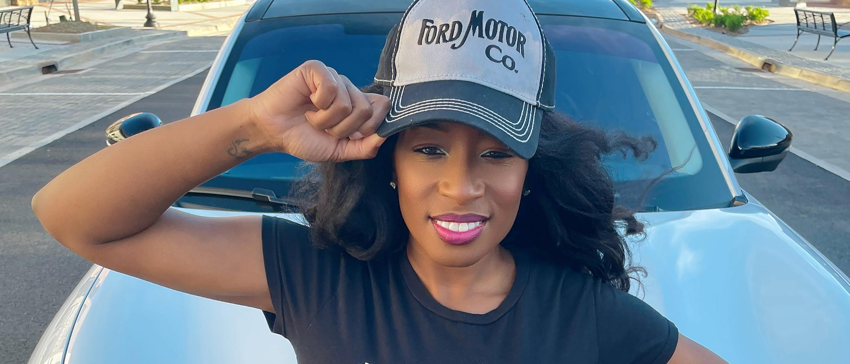 Woman standing in front of her Ford Mustang Mach-E