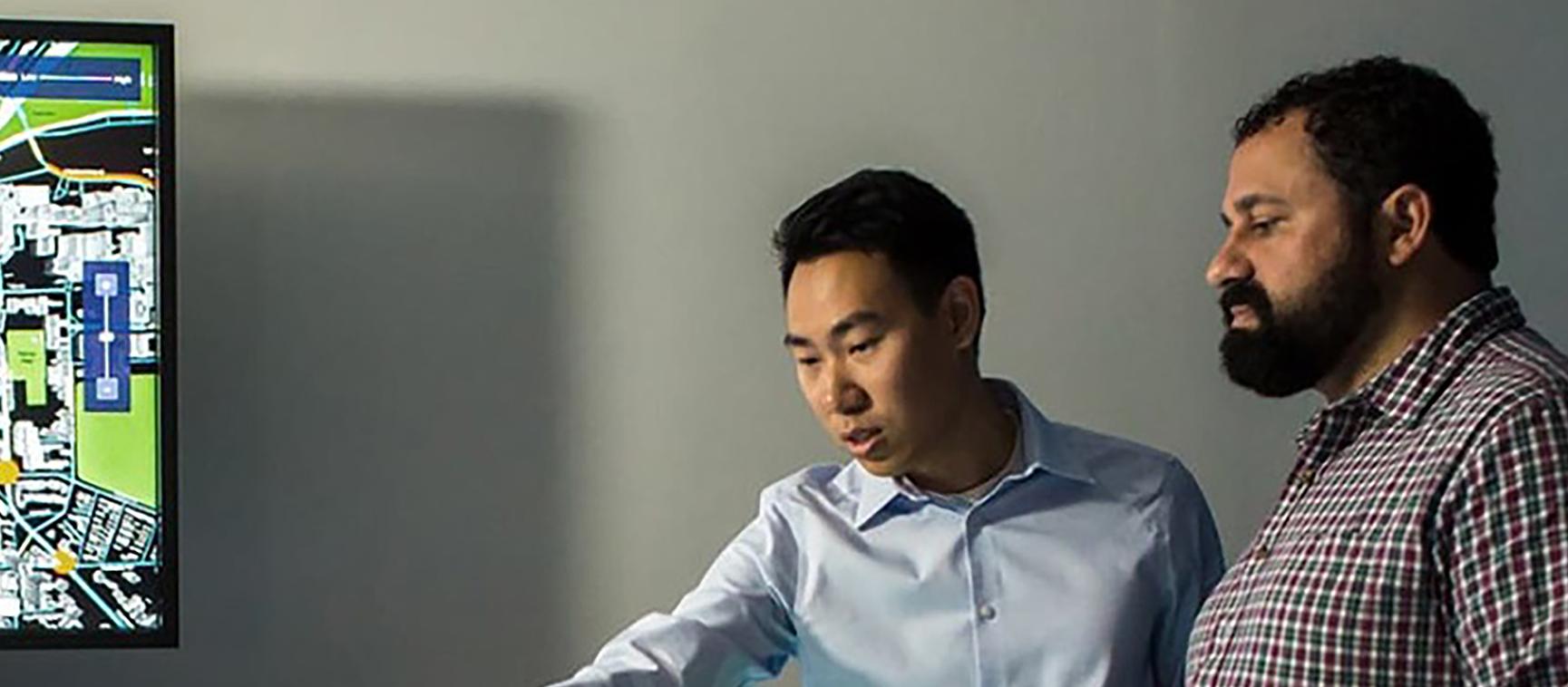 Two men observing the City Insights Studio