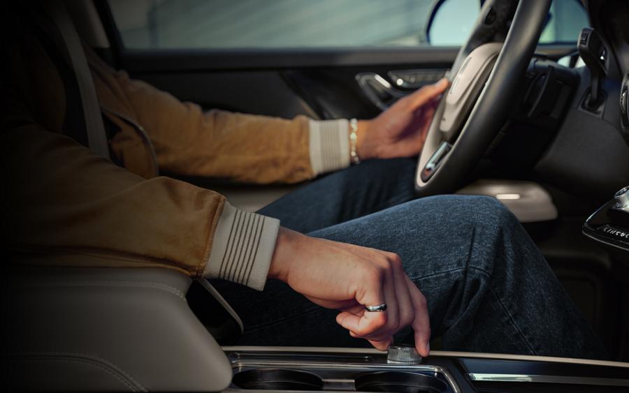 A driver turns the drive mode knob