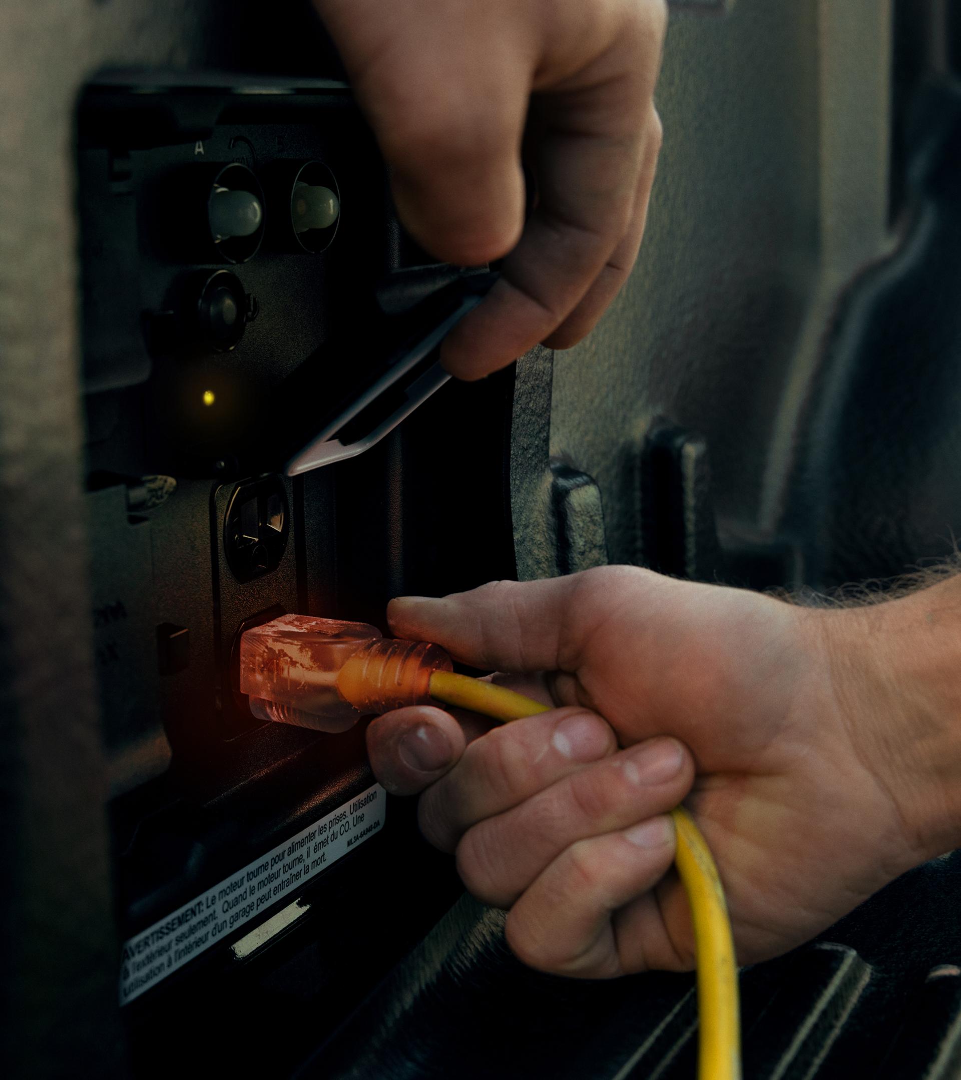 Man using a chop saw plugged into the Pro power Onboard™ feature on the tailgate of a 2026 Ford F-150® truck