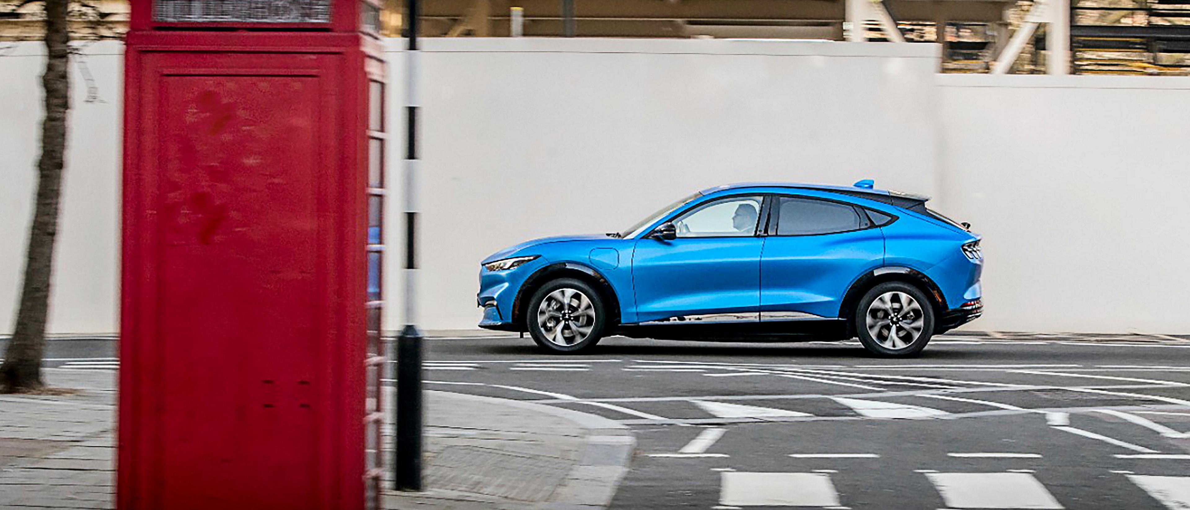 A Ford Mustang Mach-E® SUV drives along a London street