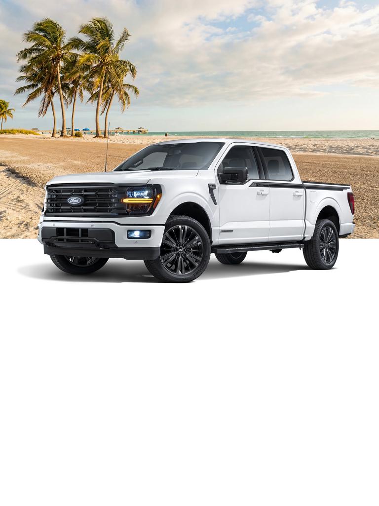 White Ford F-150® truck with the Florida Package, with a sandy beach and palm trees background