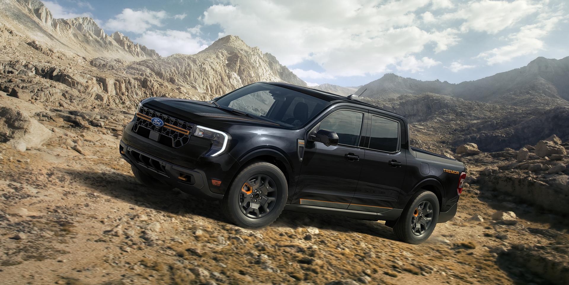2026 Maverick® Tremor® model in Shadow Black being driven on a rocky mountainside