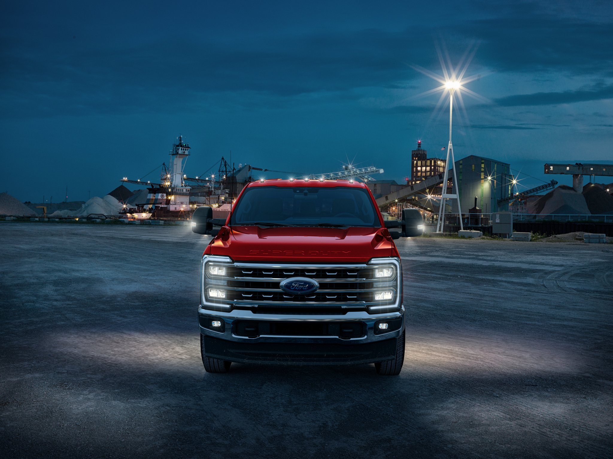 2025 Ford Super Duty® Chassis Cab with headlights on in a construction site at night